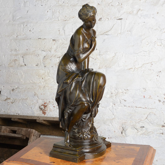 A Bronze figure of a woman seated