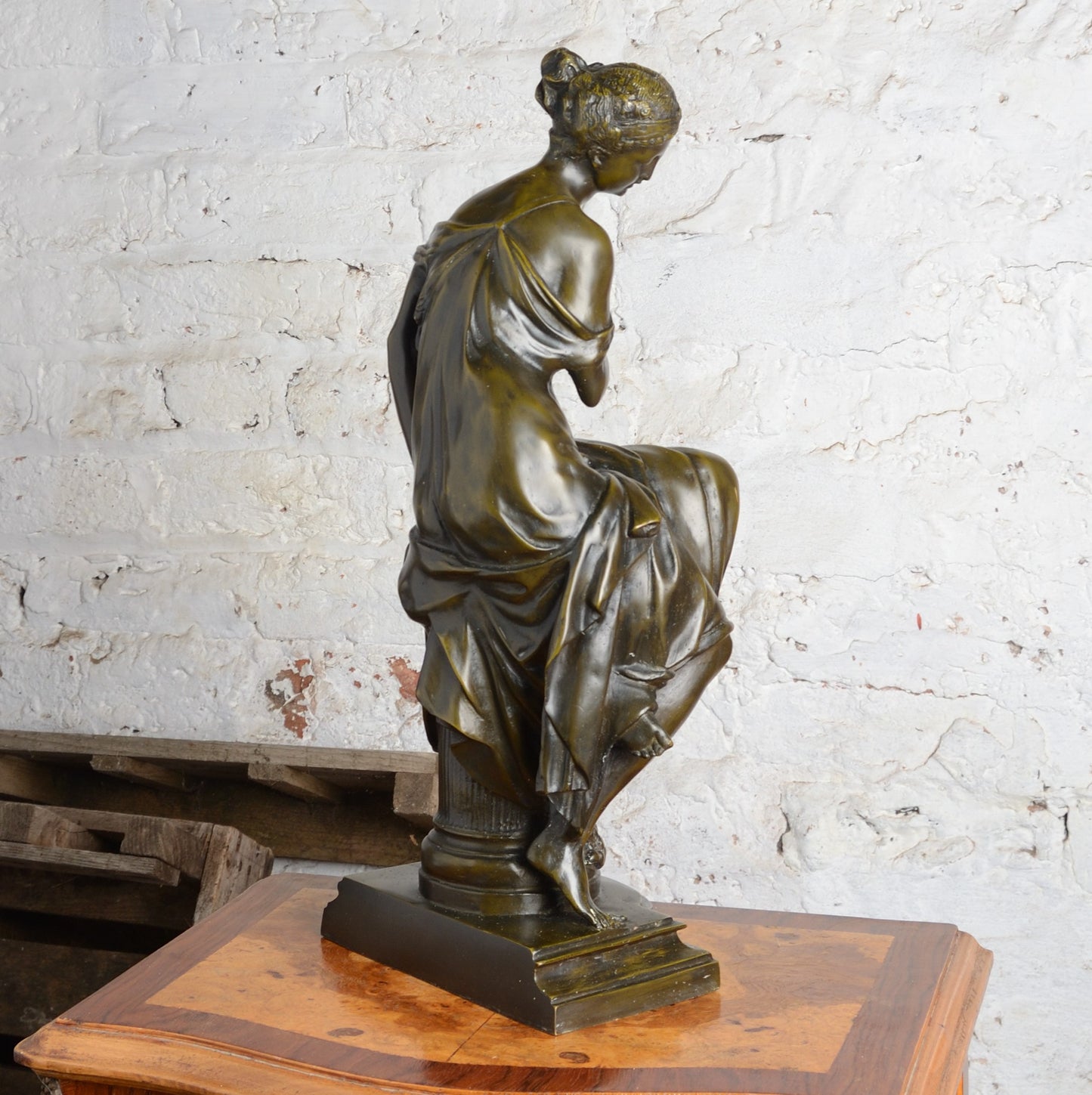 A Bronze figure of a woman seated