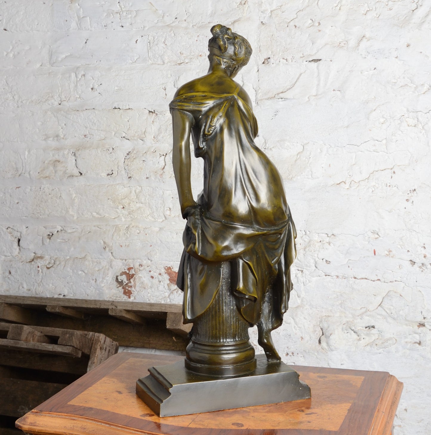 A Bronze figure of a woman seated