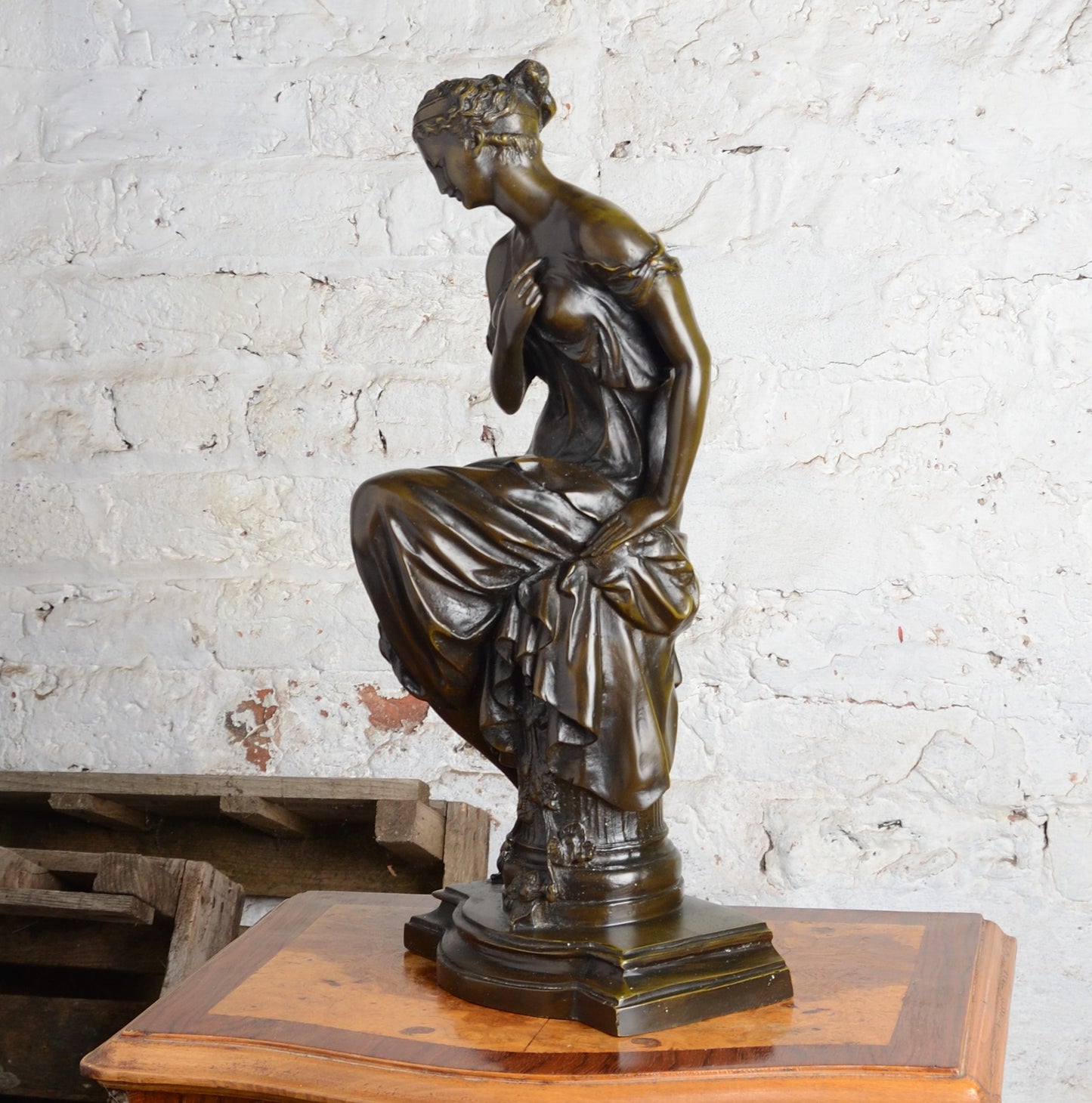 A Bronze figure of a woman seated