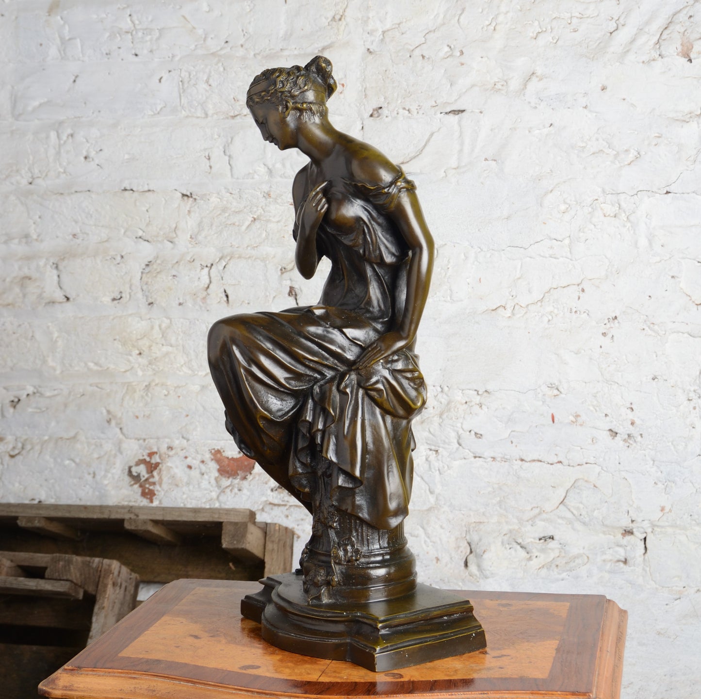 A Bronze figure of a woman seated