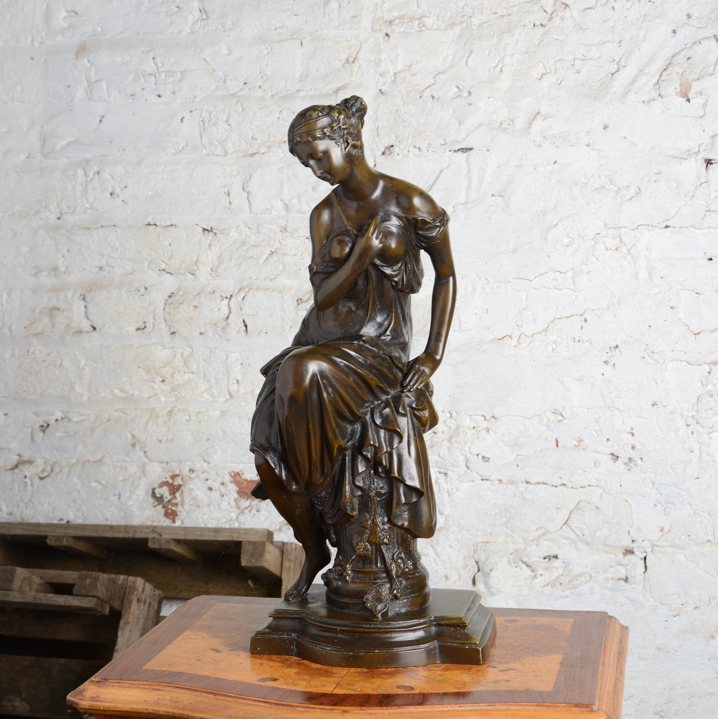 A Bronze figure of a woman seated