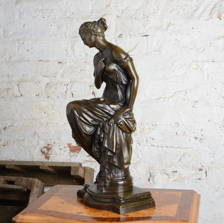 A Bronze Figure of a Woman Seated